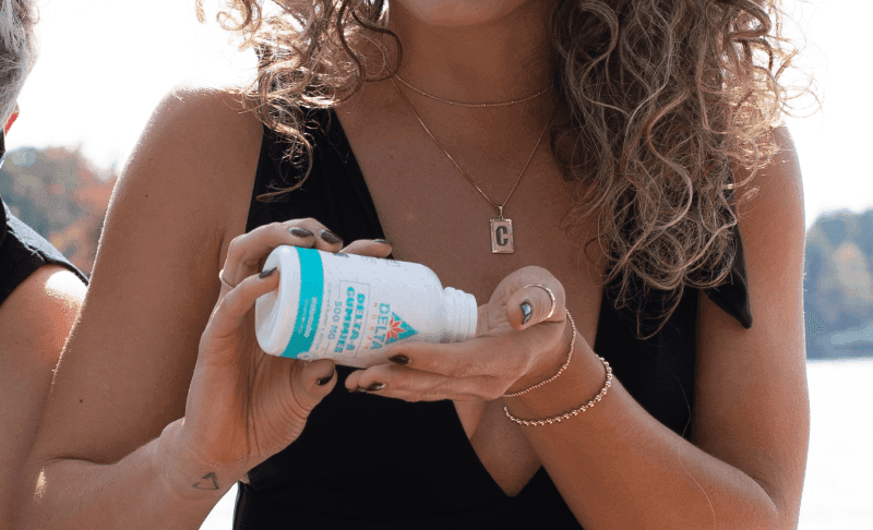 Girl pouring delta 8 edibles in hand